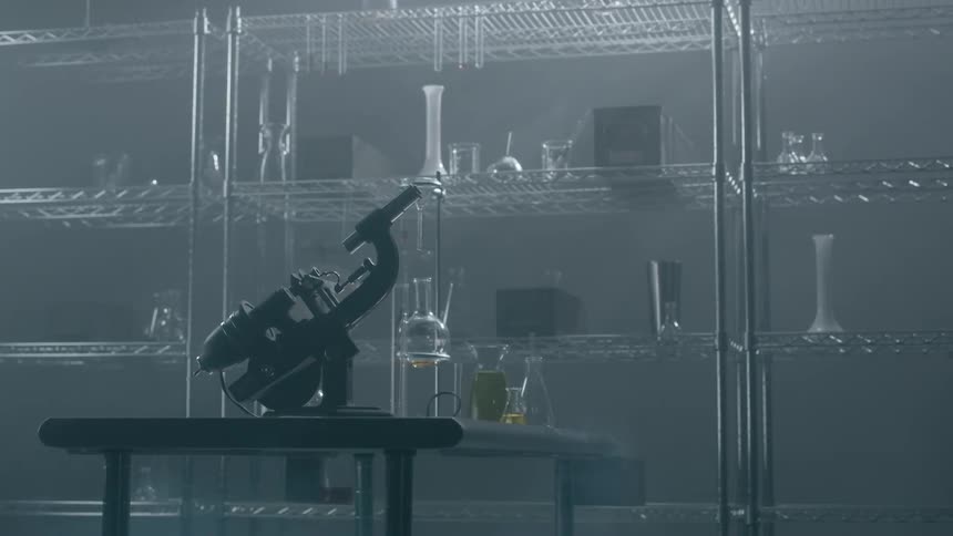 A microscope sits on the table of a lab