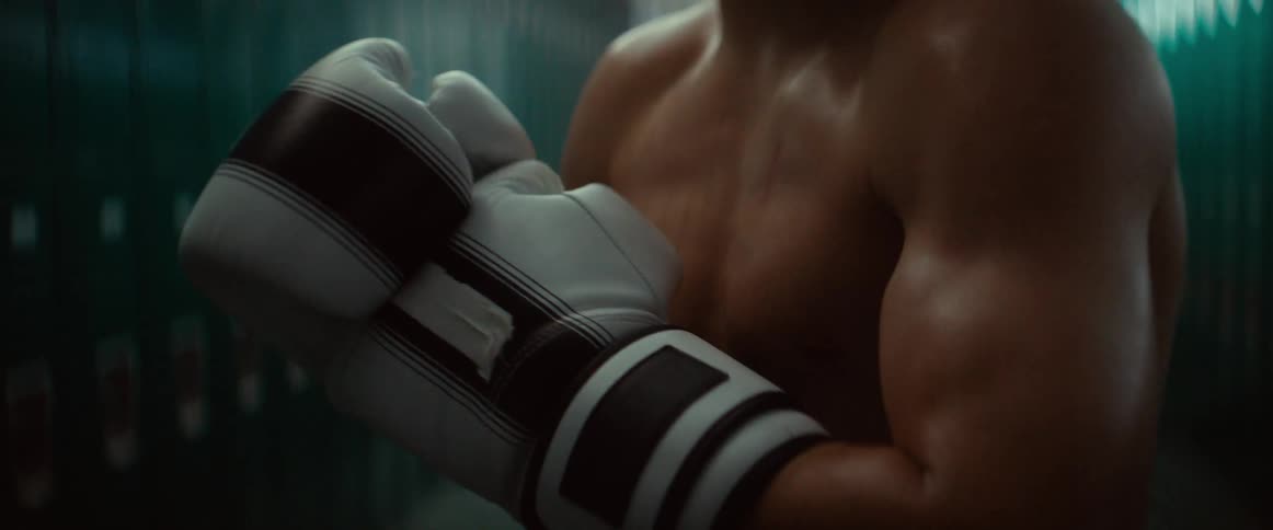 A boxer puts on his boxing gloves