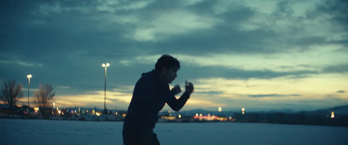 A man is shadowboxing outside
