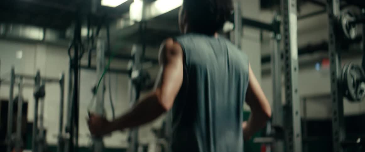 A man is jumping rope inside of a gym surrounded by exercise machines