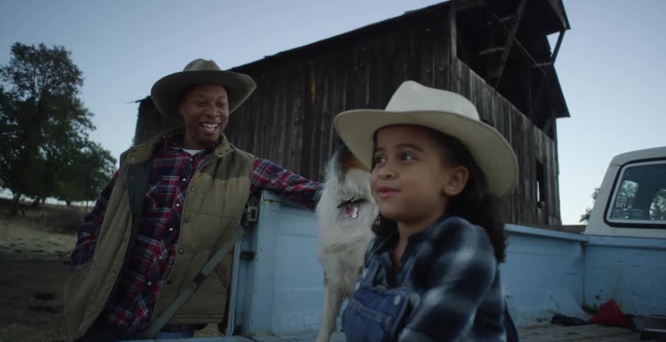 A man talks to a child on the farm