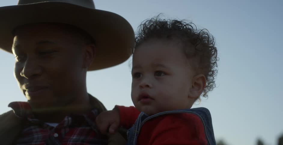 A father holds his son outside