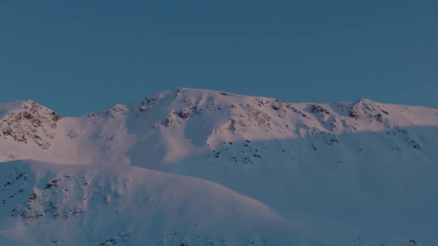 Snow covers a mountain ridge