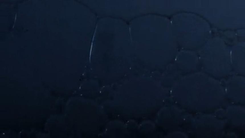 Bubbles rising and falling underwater in waves