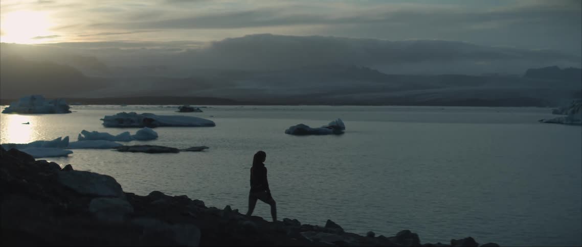 A woman standing at the edge of the sea
