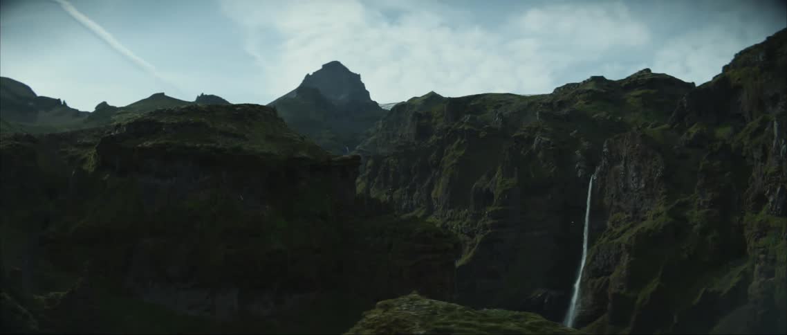 A waterfall flowing over a cliff in nature in the daytime