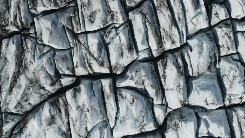 Cracked ice pieces floating together with dark edges