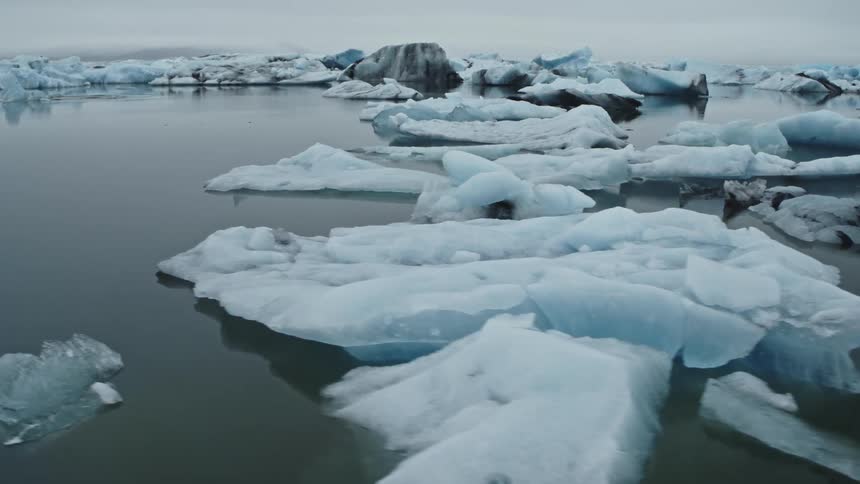 Pieces of melting ice are floating in the arctic water