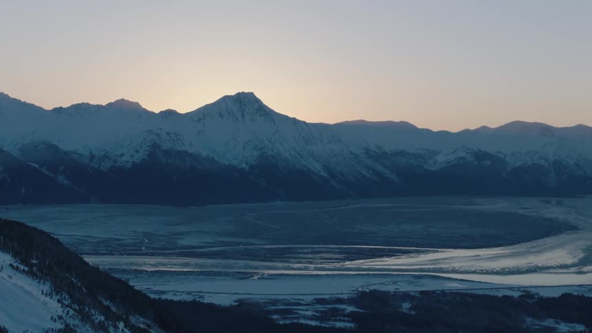 The mountain ahead is covered with snow at sunset