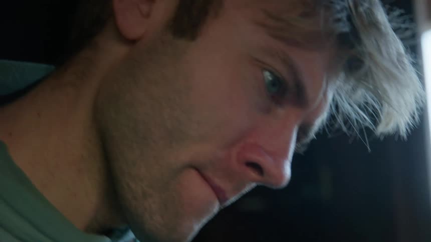 A man is looking back and forth at something