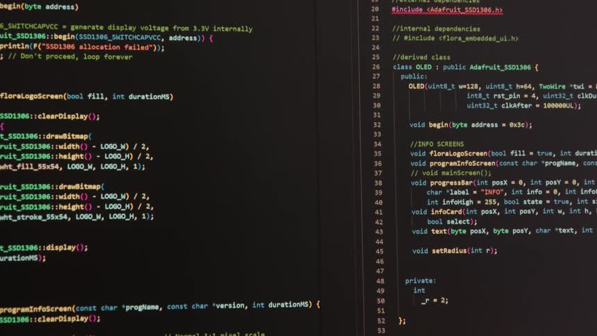 A wide computer screen is populated with multiple lines of computer programming code