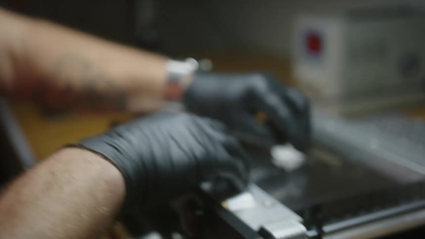 A man is cleaning a piece of equipment