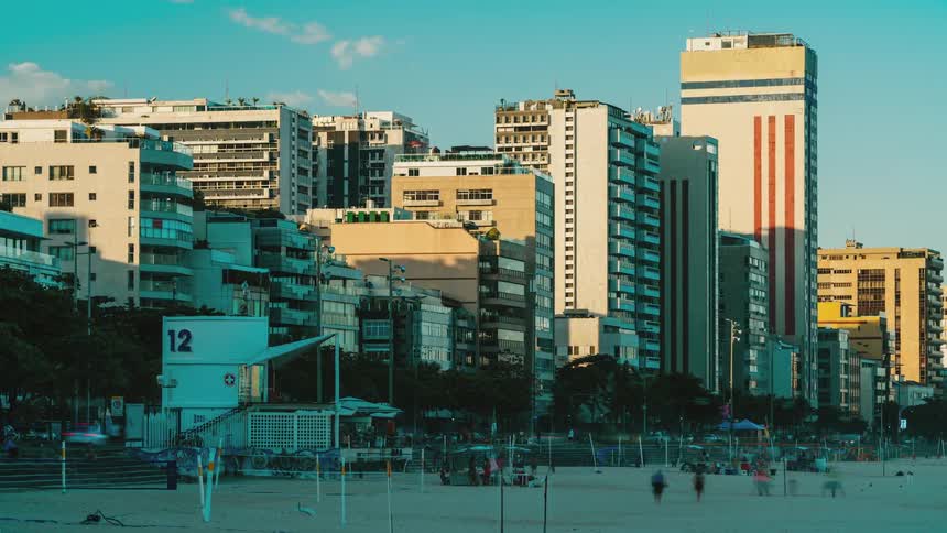Boardwalk in rio de janeiro with buildings in background and people moving at high speed