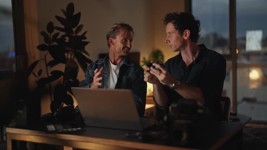 Two men are having a conversation together indoors