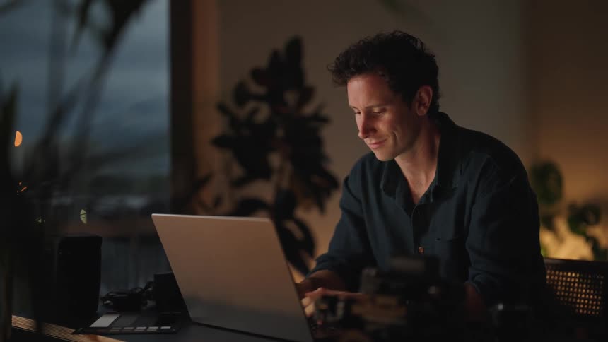 A man is at his desk typing