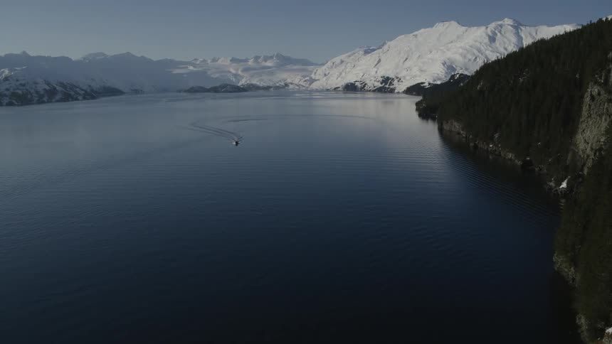 A boat floats on a mountain lake