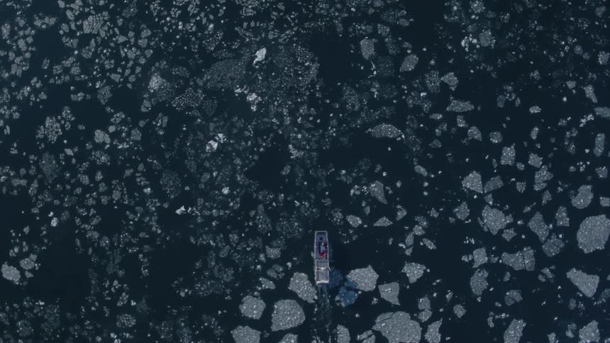A boat is wading through the ice below