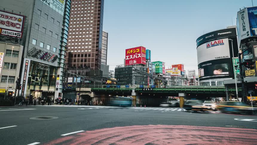 A time lapse taken of a metropolitan area shows countless vehicles and pedestrians passing by
