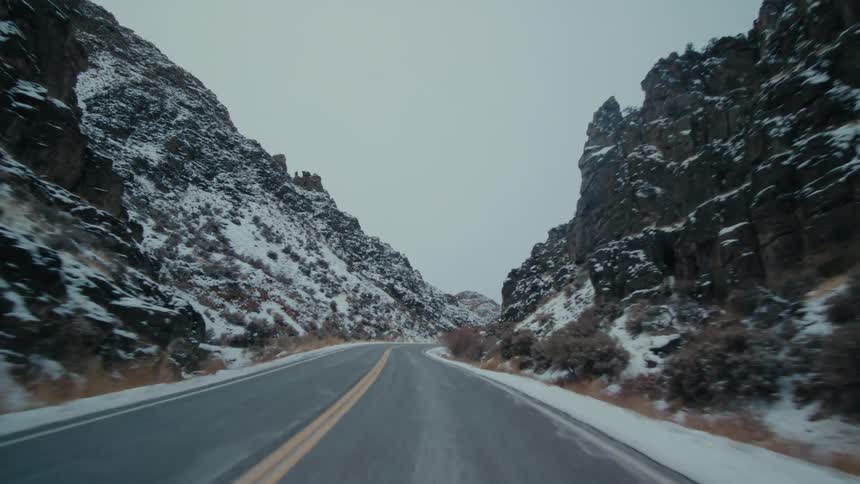 Highway passes between snow covered rock slopes