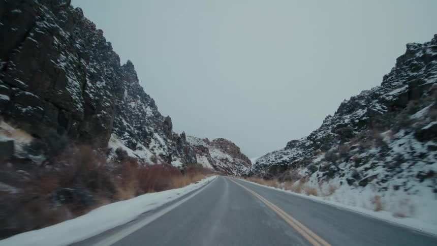 Highway winds past snow covered slopes