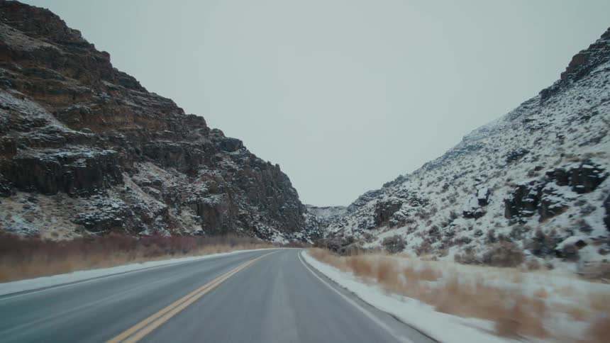 Highway passes between two snow covered mountains