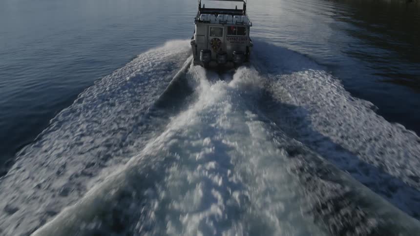 Waves move behind a ship sailing
