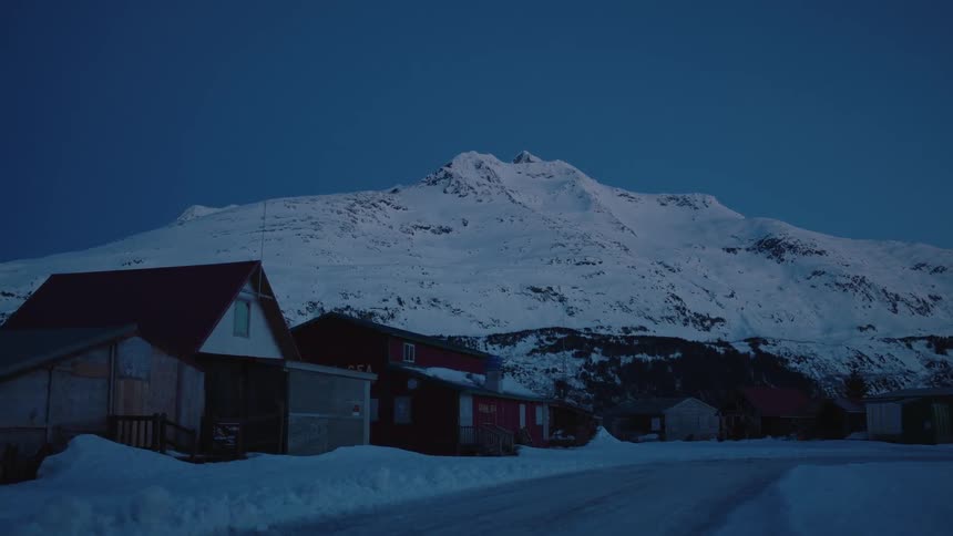 House are close to this snow covered mountain