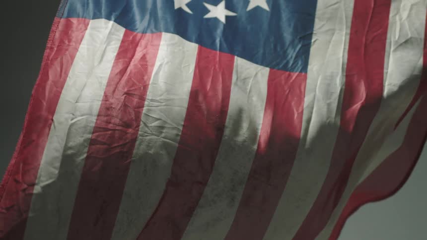 A colonial flag billows in the wind