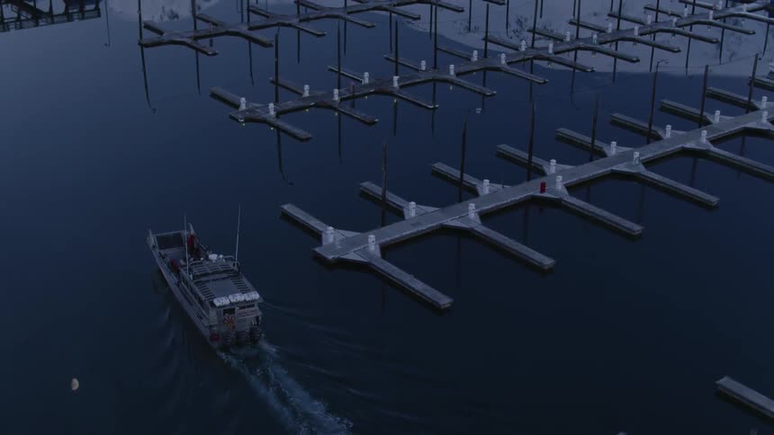 A boat pulls past a dock