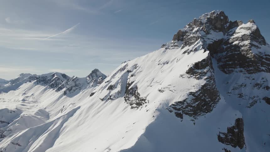 A mountain range and peak covered in snow