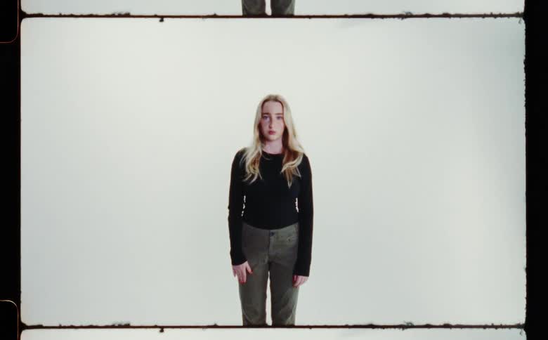 A woman is posing in the frame