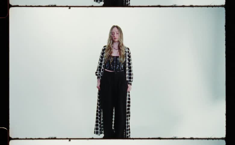 A model is posing with clothing on