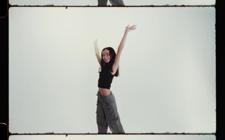A girl is smiling and standing in a room