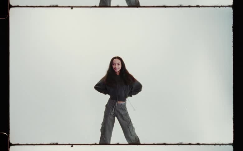 A teenage girl striking poses and smiling