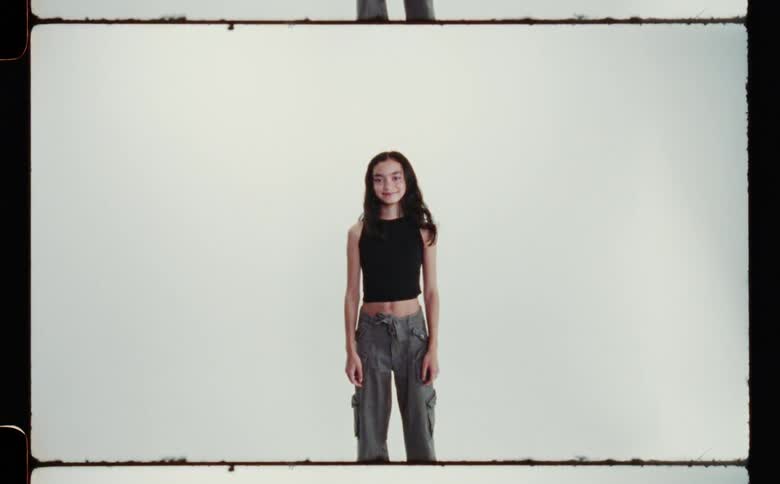 Young girl with long hair standing smiling for camera