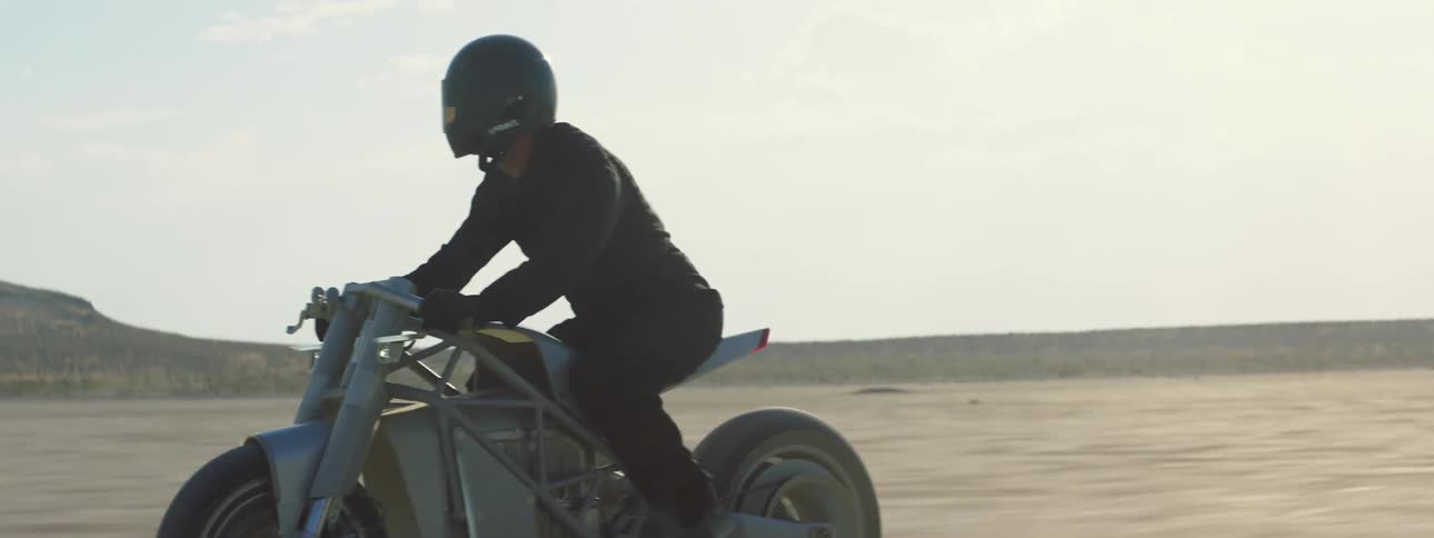 A person is riding a motorcycle in the desert