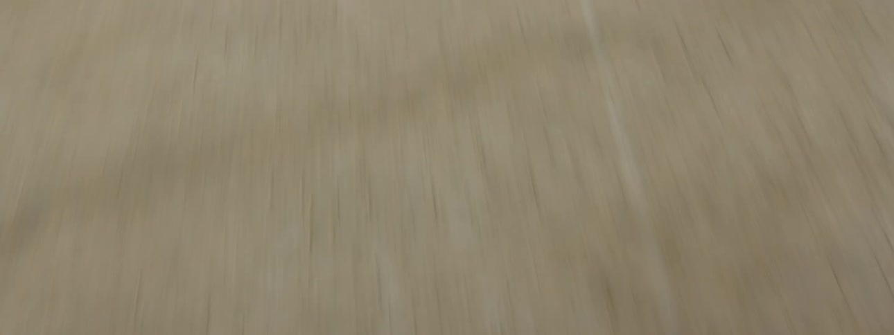 Biker with black helmet and jacket rides bike in the desert