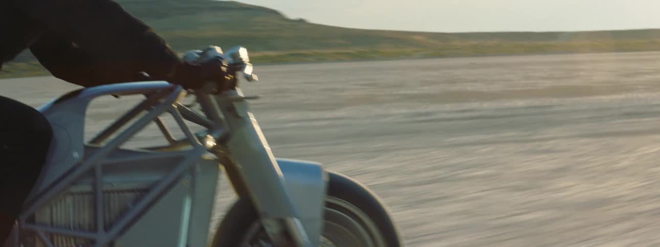 A person is racing their motorcycle in the desert