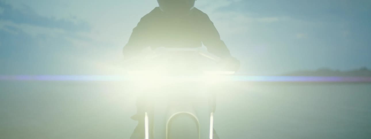 A person is driving their motorcycle through the desert