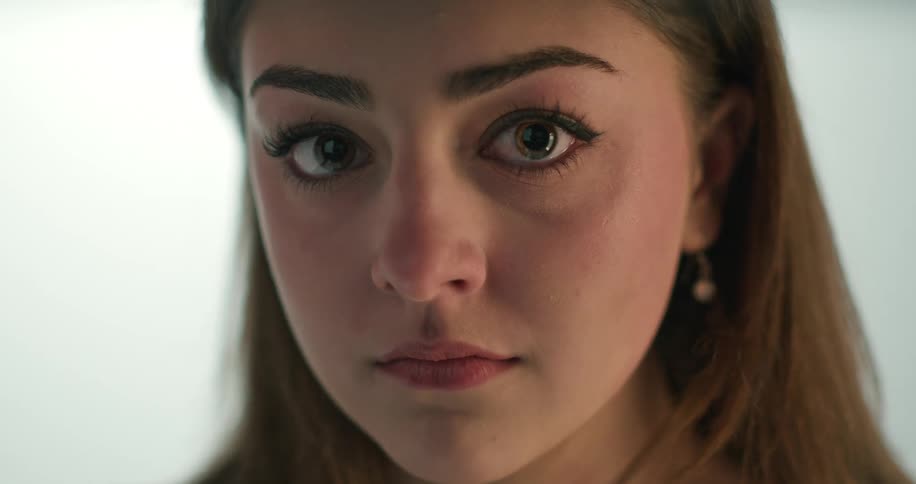 Close up view of a woman wearing makeup is displayed