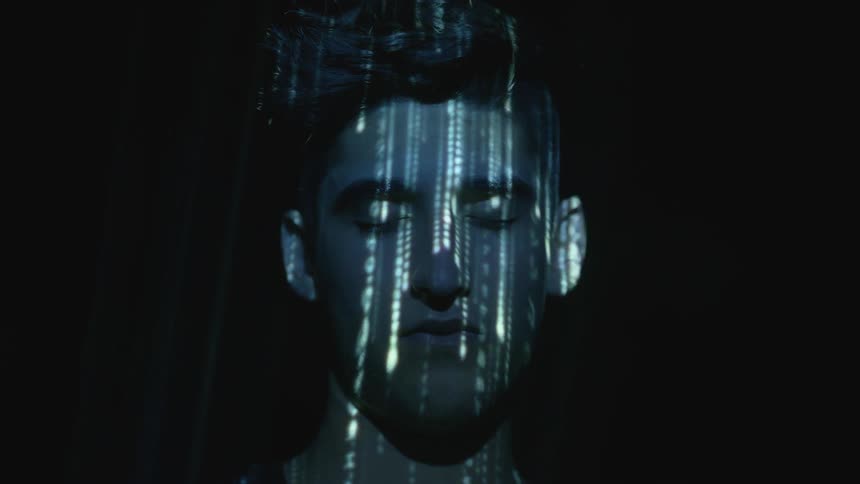 A man has lights flashing on his face