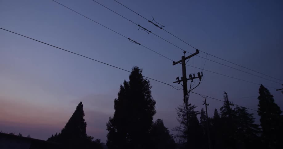 The pole to the power line is destroyed and the top is hanging