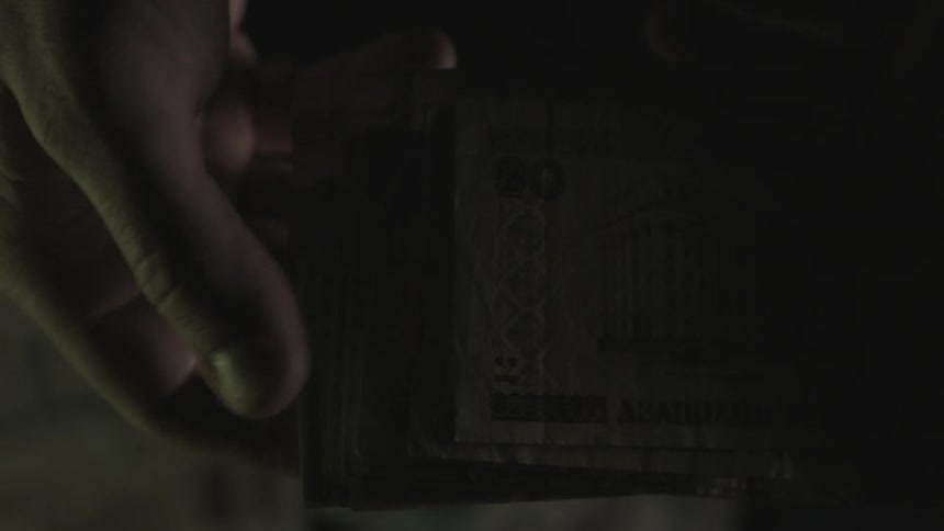 A person flips through paper money