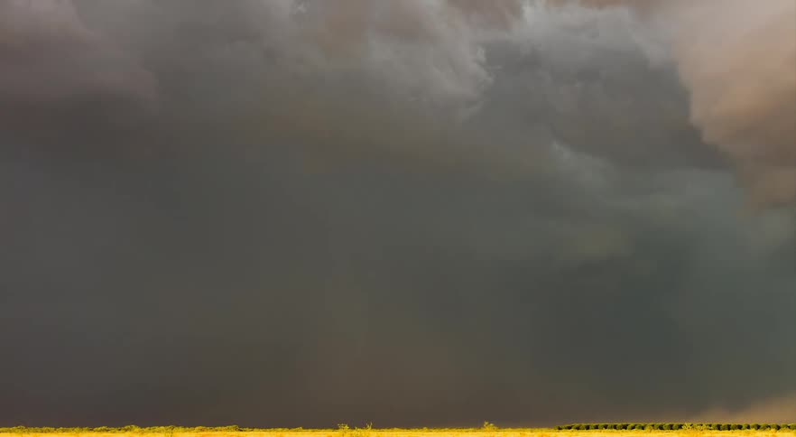 Wind is blowing dust as storm clouds are swirling and forming