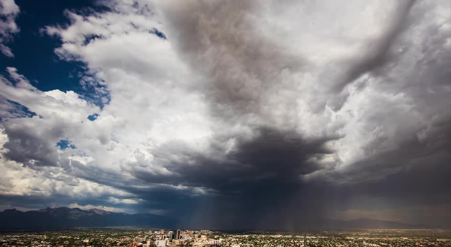 Clouds float over city and highway
