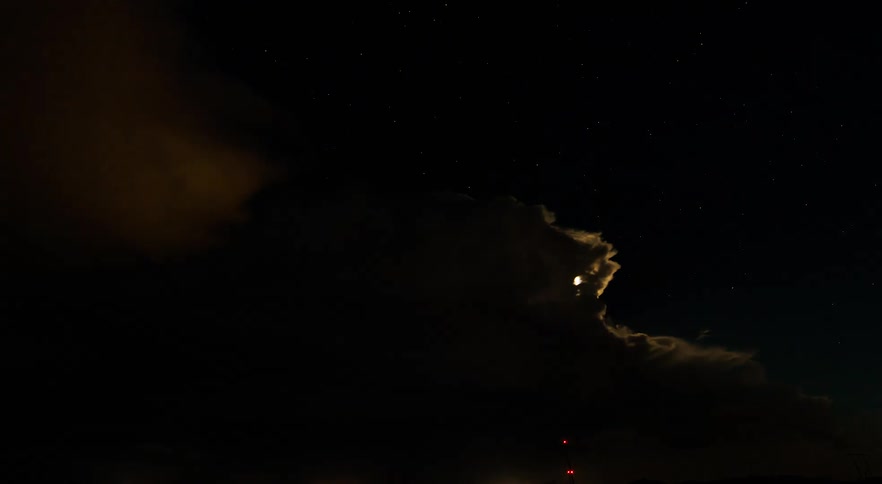 A thunderstorm flashing against the full moon