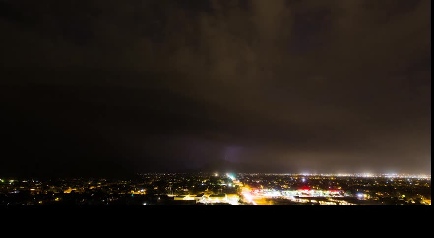 A time lapse of a lightning storm over a bright lit up city