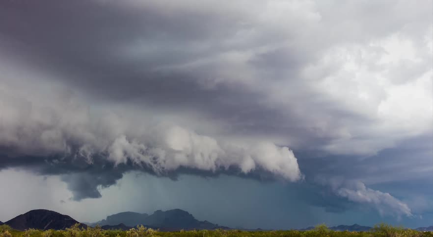 A monsoon storm system shelf cloud moving over a plain