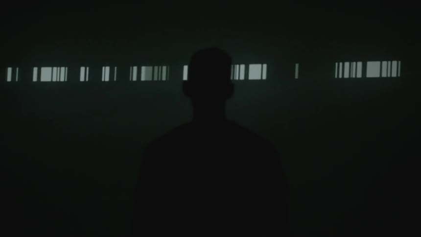 A man watches lights flash on a wall