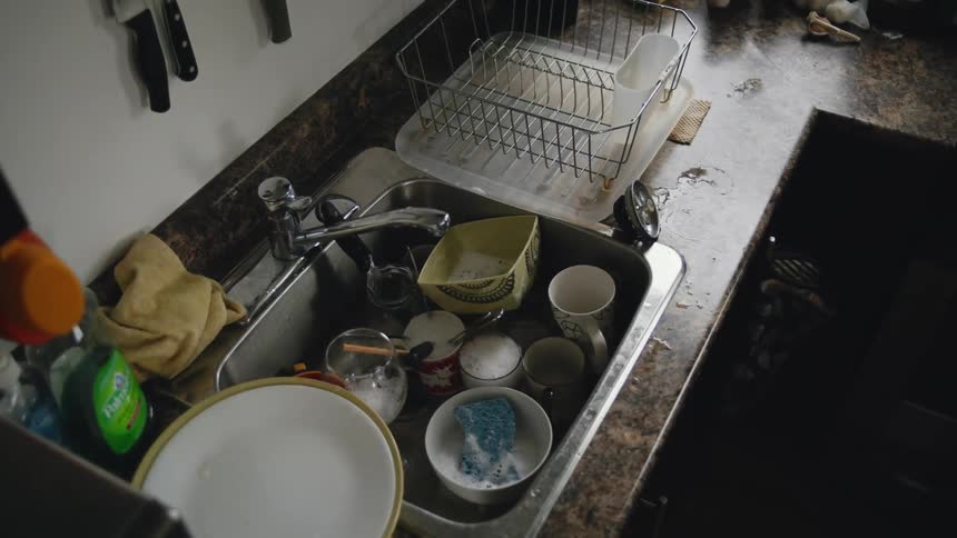A person reaches to the sink